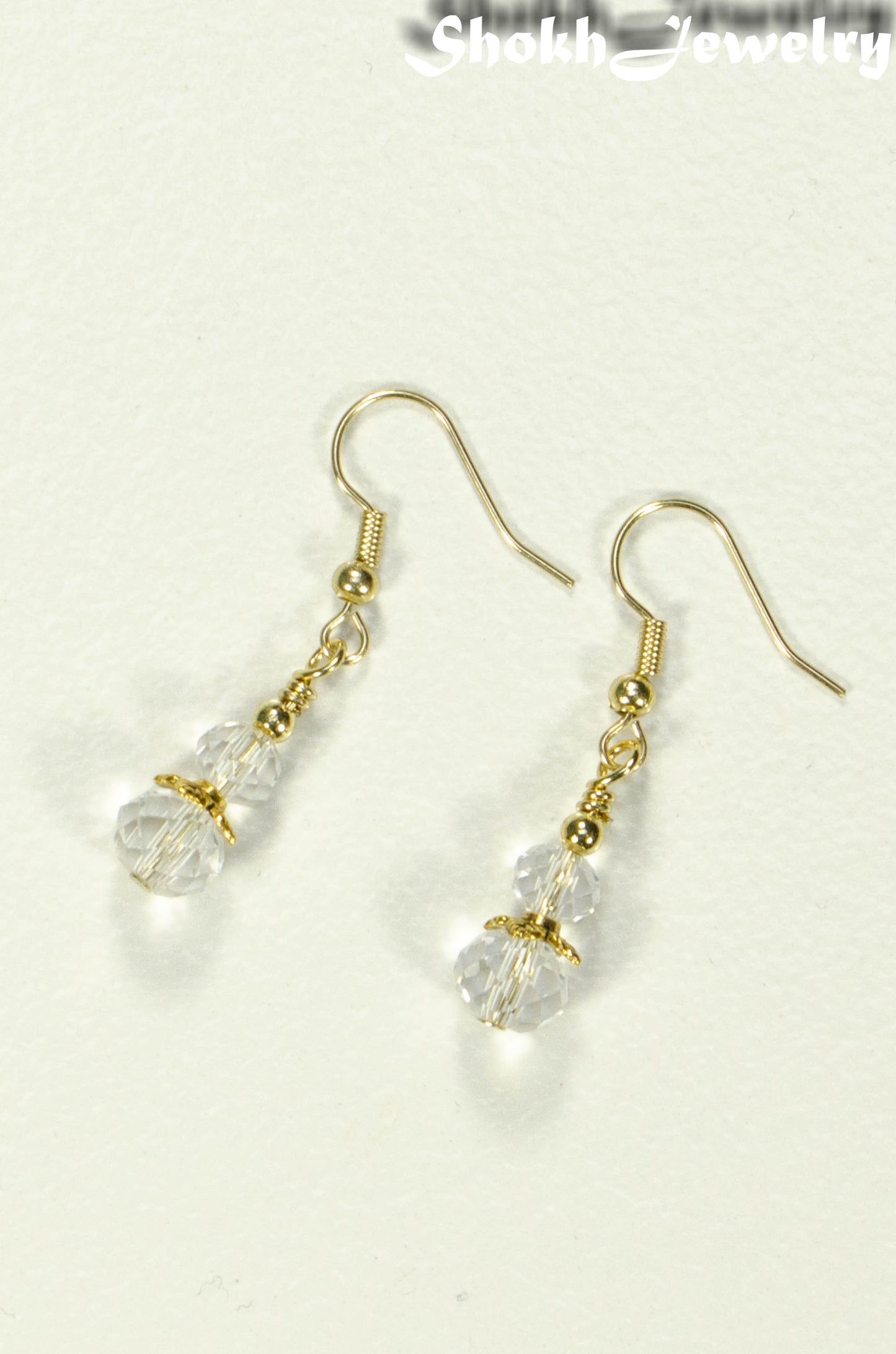 Top view of Small Clear Glass Bead Dangle Earrings.