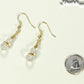 Small Clear Glass Bead Dangle Earrings beside a dime.