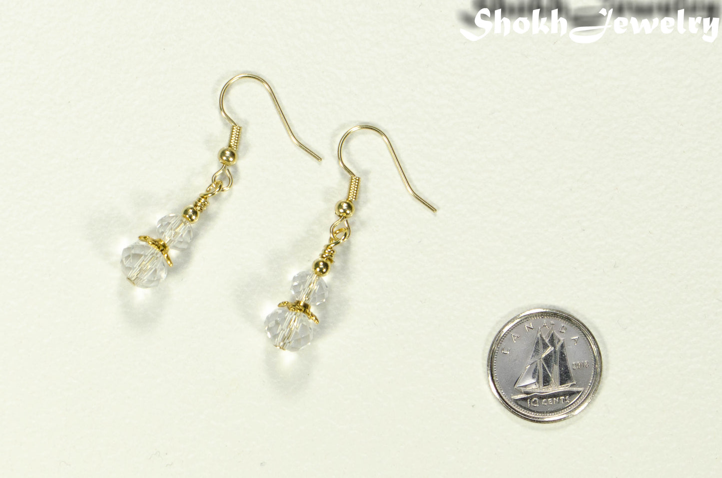 Small Clear Glass Bead Dangle Earrings beside a dime.