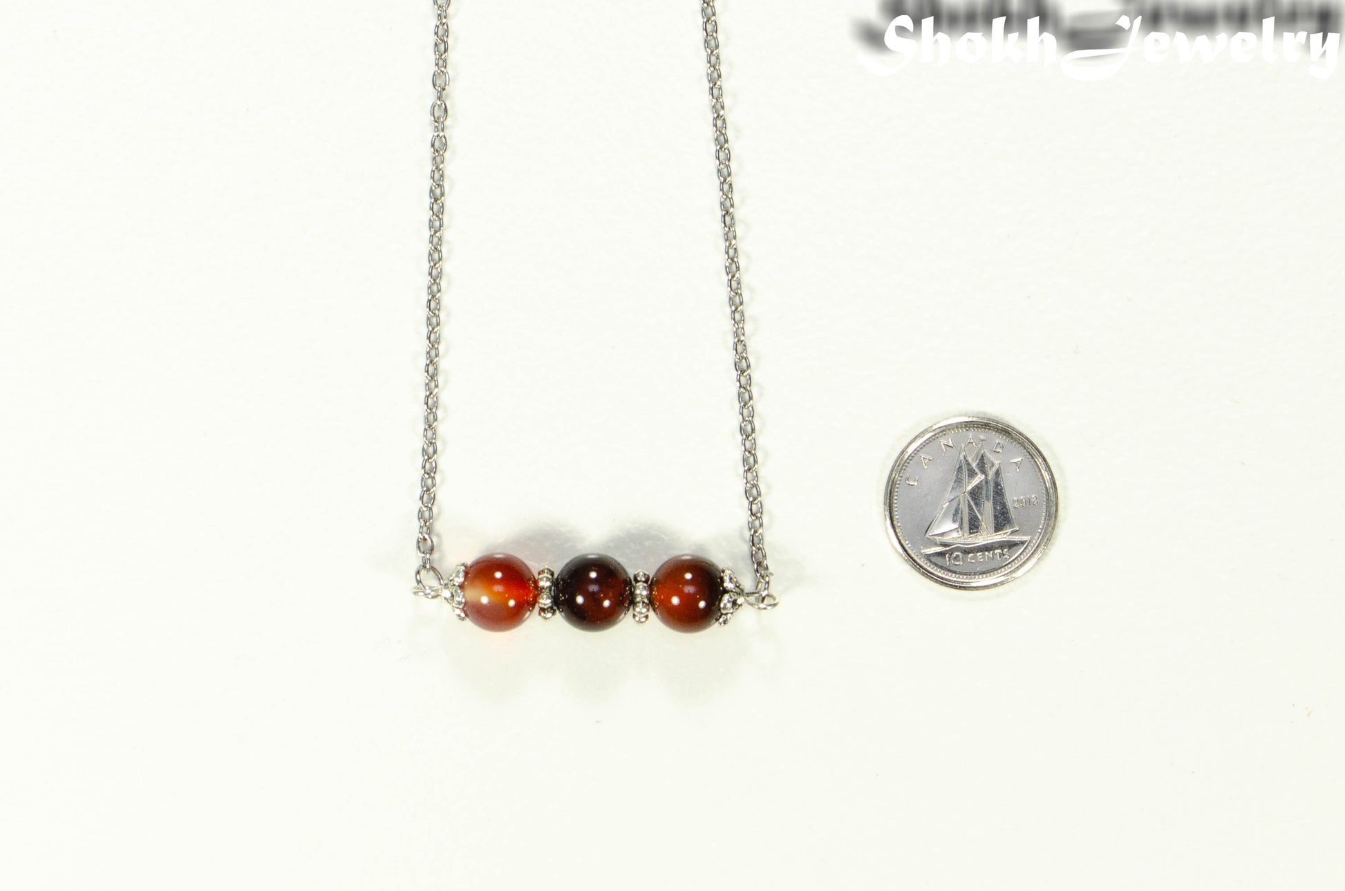 Carnelian and Dainty Chain Choker Necklace beside a dime.