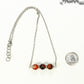 Carnelian and Dainty Chain Choker Necklace with a clasp beside a dime.