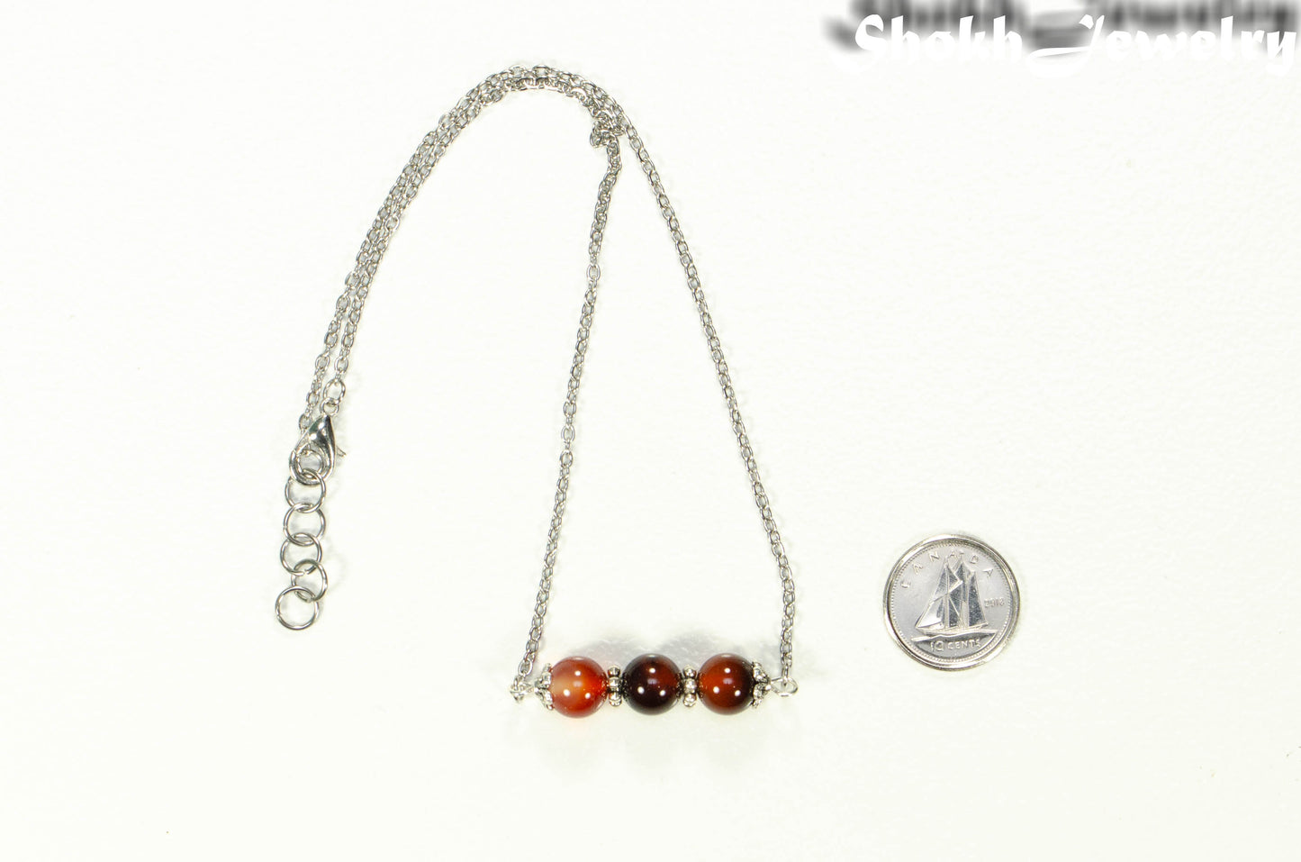 Carnelian and Dainty Chain Choker Necklace with a clasp beside a dime.