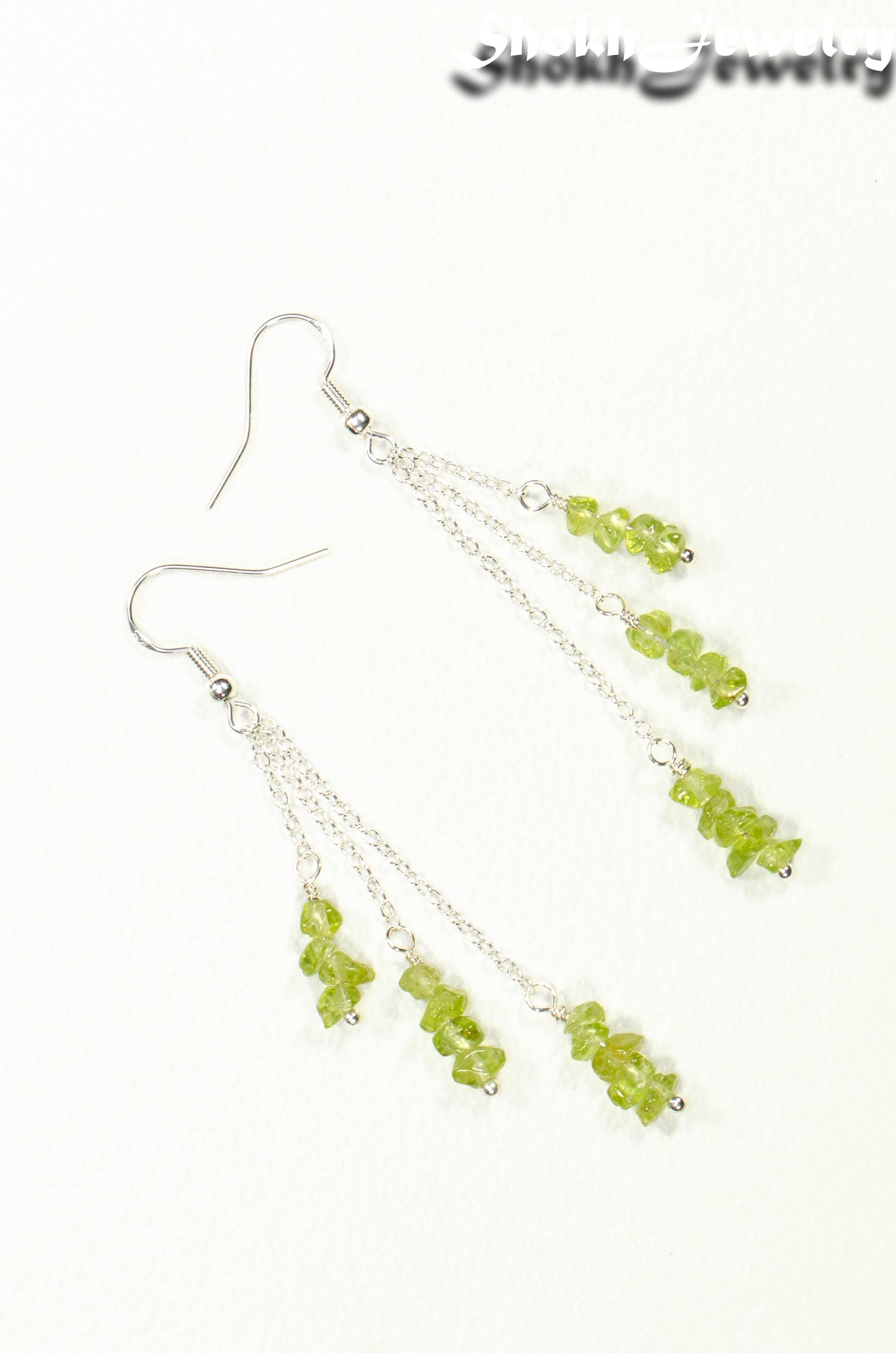 Top view of Long Silver Plated Chain and Peridot Chip Earrings