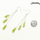 Long Silver Plated Chain and Peridot Chip Earrings beside a dime.