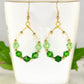 Ombre Green Glass Crystal Hoop Earrings displayed on a tea cup.