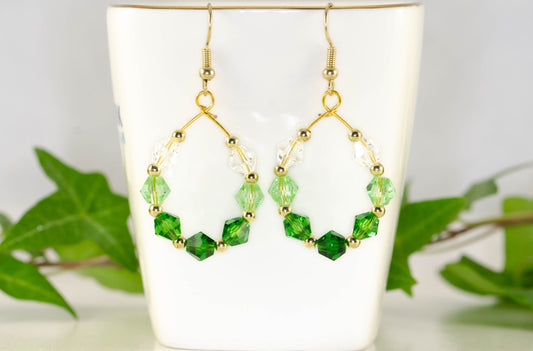 Ombre Green Glass Crystal Hoop Earrings displayed on a tea cup.