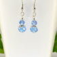 Close up of Small Light Blue Glass Bead Dangle Earrings.