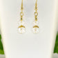 Close up of Small Clear Glass Bead Dangle Earrings.