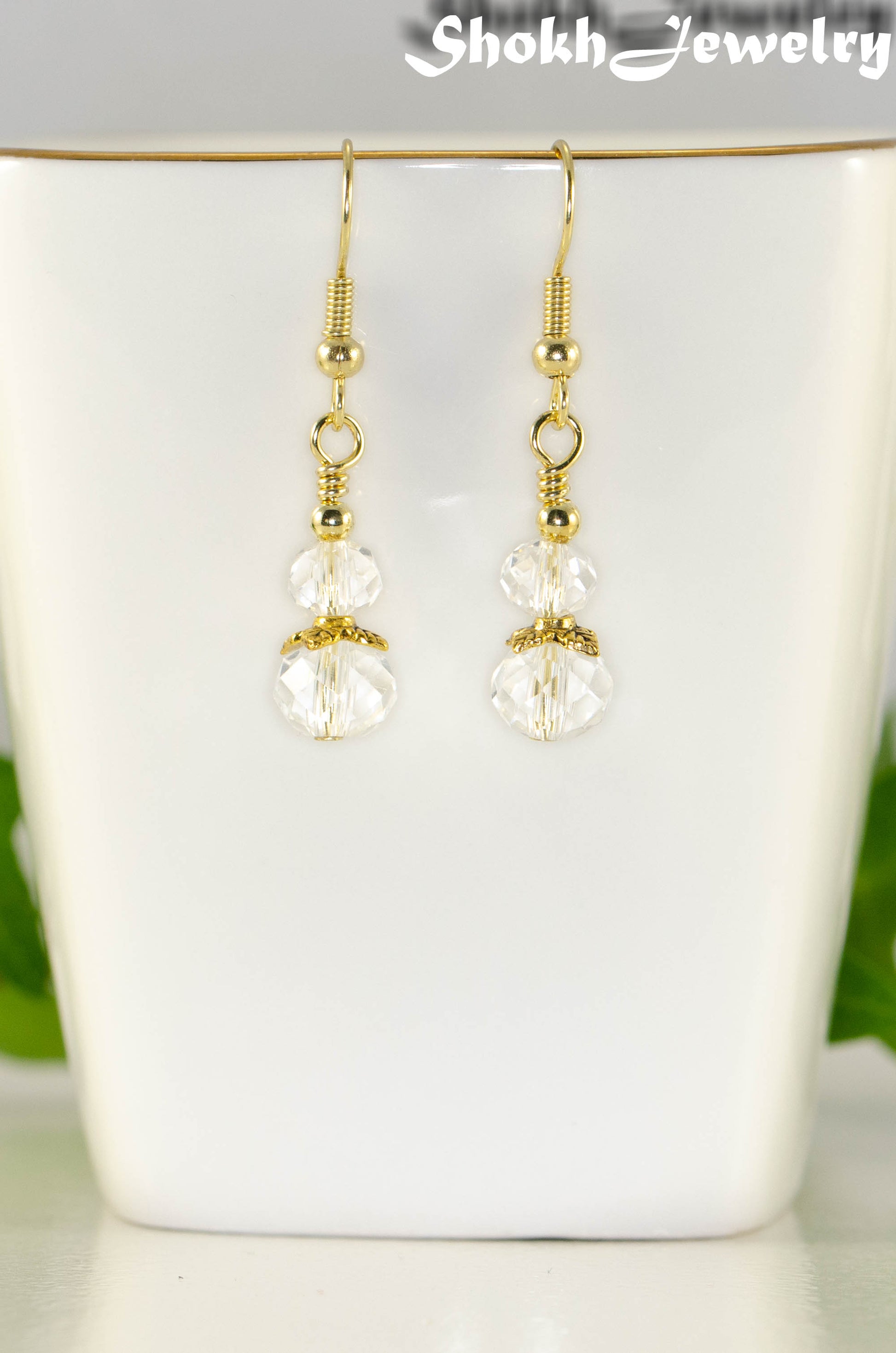 Close up of Small Clear Glass Bead Dangle Earrings.