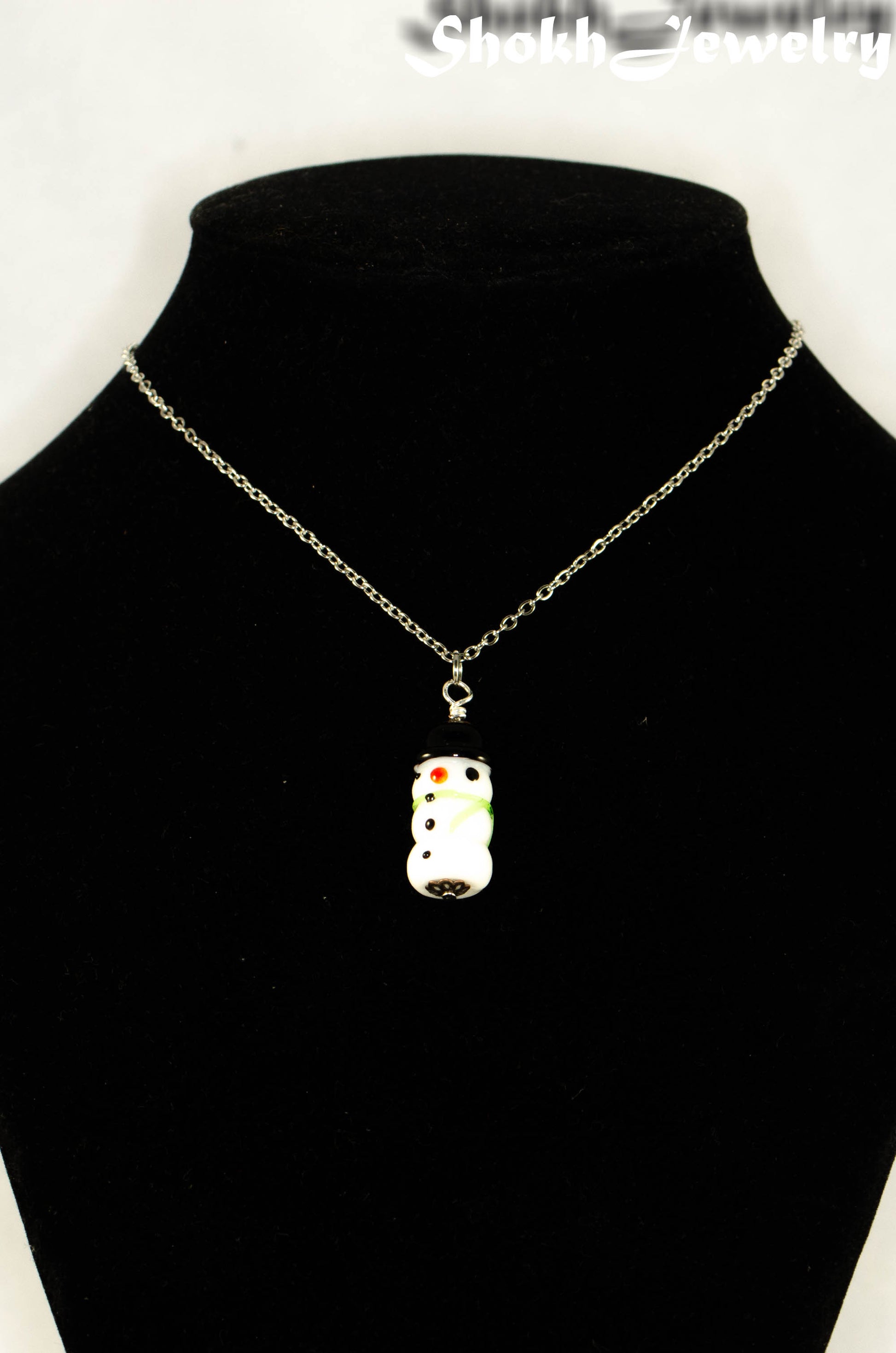 Glass Bead Snowman Pendant Necklace displayed on a bust.