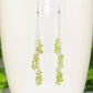 Close up of Long Silver Plated Chain and Peridot Chip Earrings.