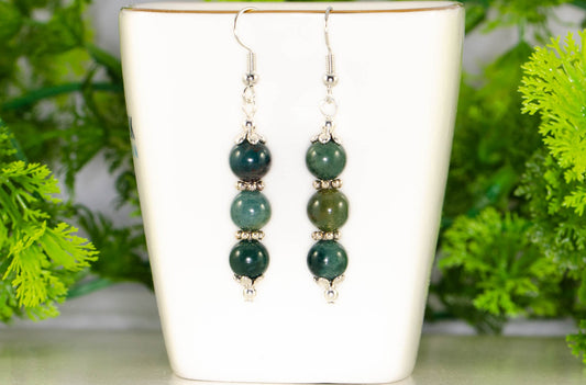 Natural Moss Agate Beaded Bar Earrings displayed on a tea cup.