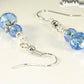 Close up of Small Light Blue Glass Bead Dangle Earrings.