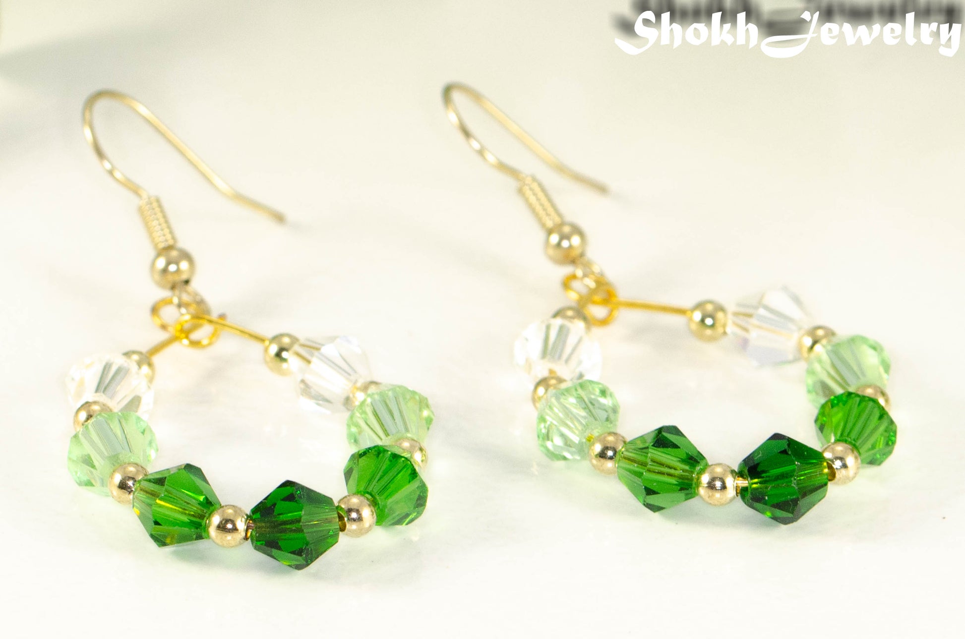 Close up of Ombre Green Glass Crystal Hoop Earrings.