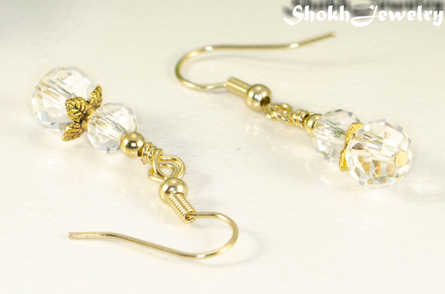 Close up of Small Clear Glass Bead Dangle Earrings.