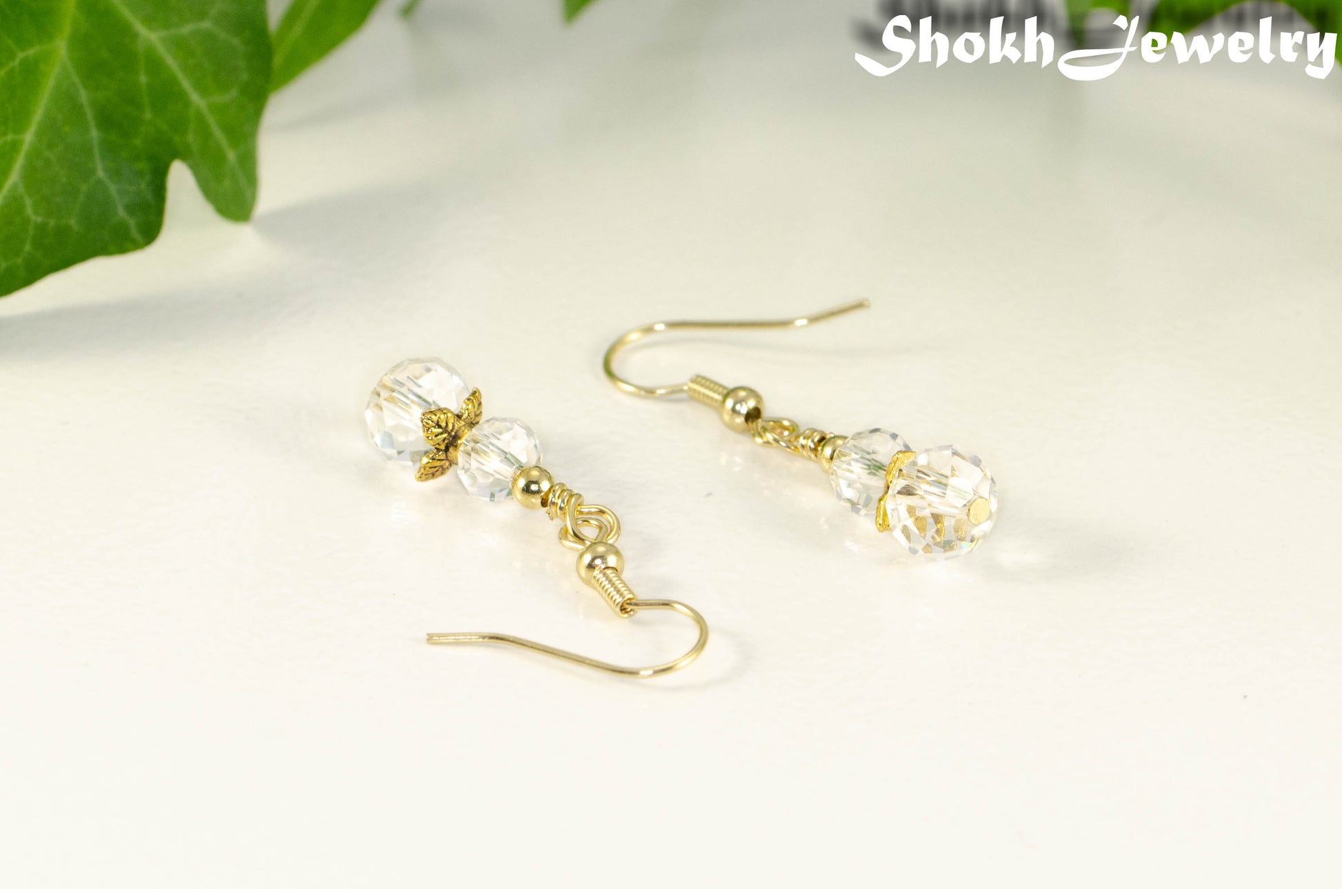 Small Clear Glass Bead Dangle Earrings with gild plated ear wires.