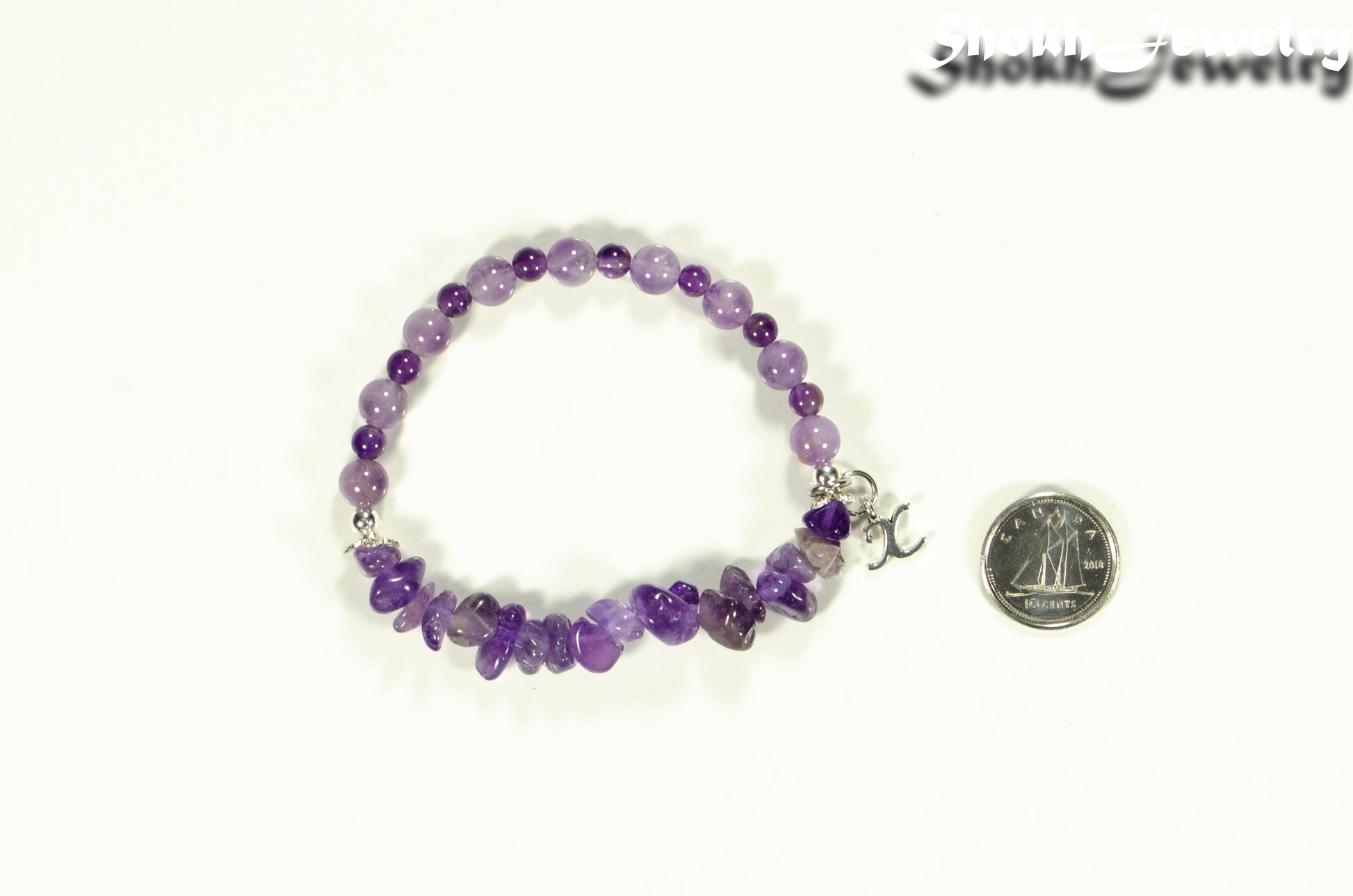 Amethyst Chip and Beads Bracelet with Initial beside a dime.