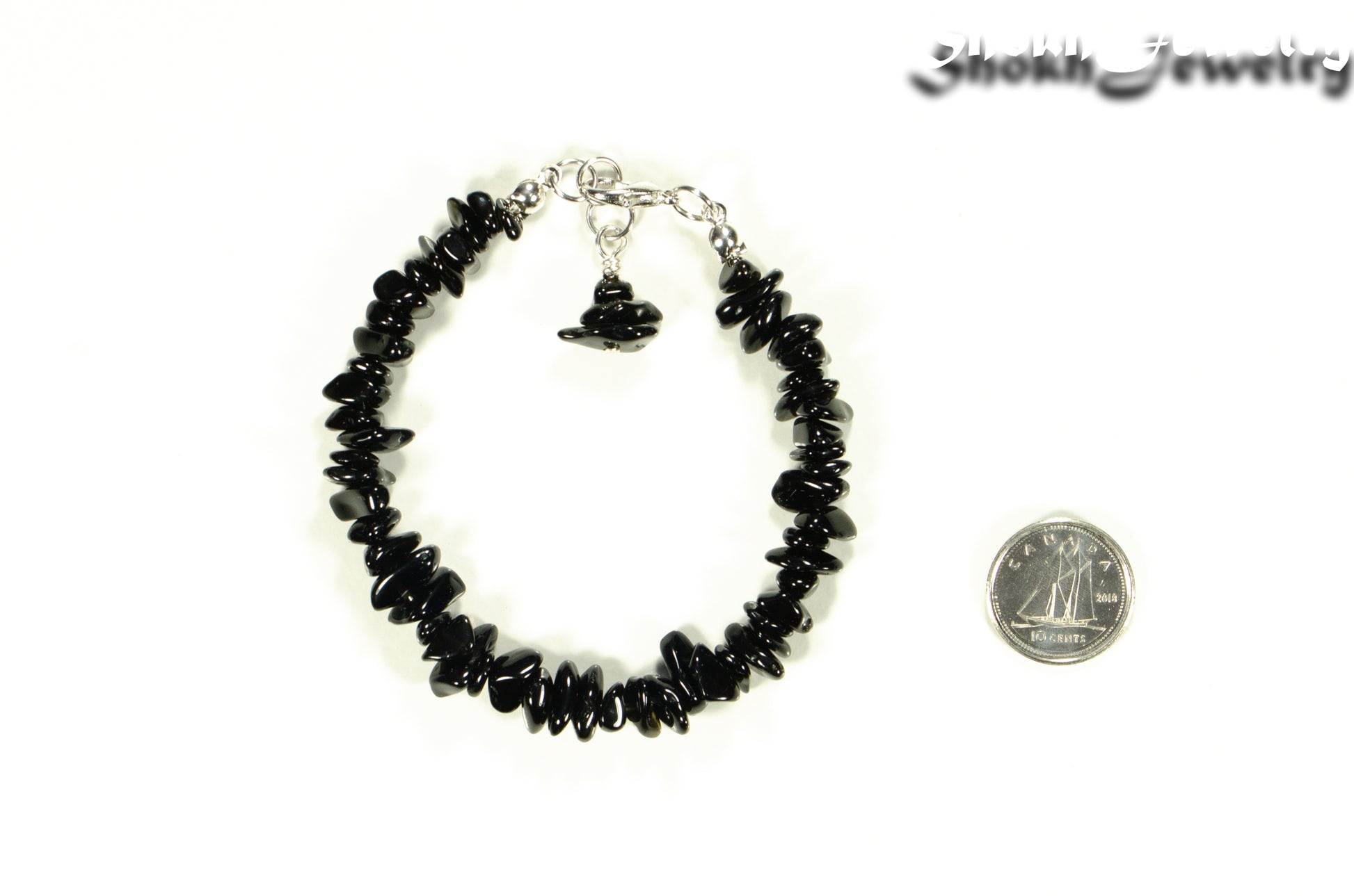 Natural Black Obsidian Crystal Chip Bracelet beside a dime.