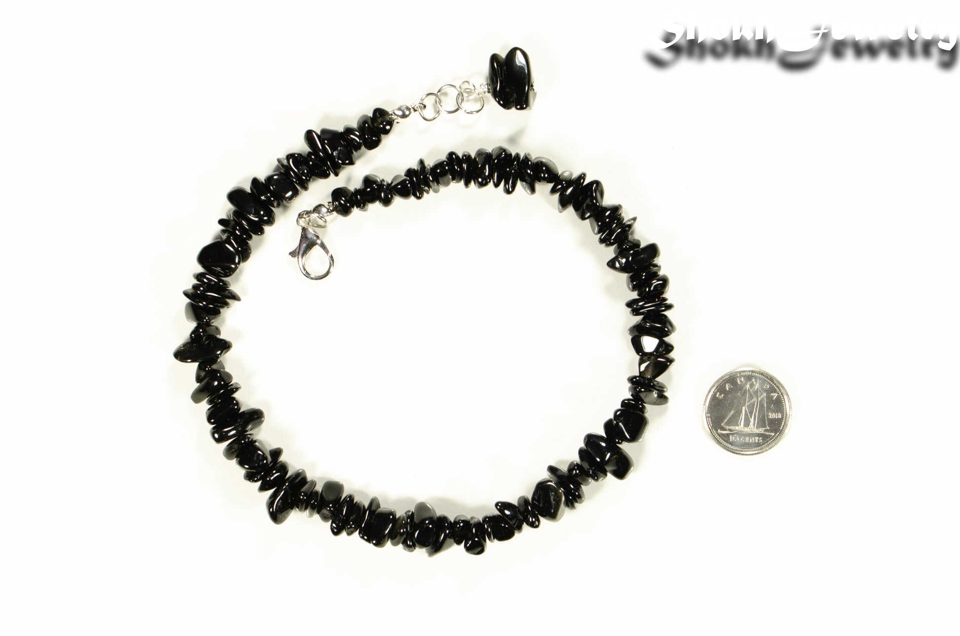 Natural Black Obsidian Crystal Chip Anklet beside a dime.