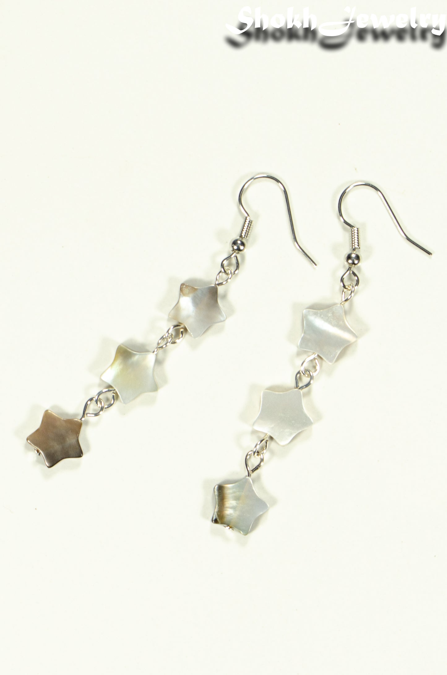 Top view of Long Natural Seashell Star Earrings.