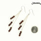 Silver Plated Chain and Garnet Crystal Earrings beside a dime.