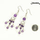 Statement Amethyst Crystal Chandelier Earrings beside a dime.