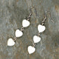 Top view of Long White Seashell Hearts Earrings.