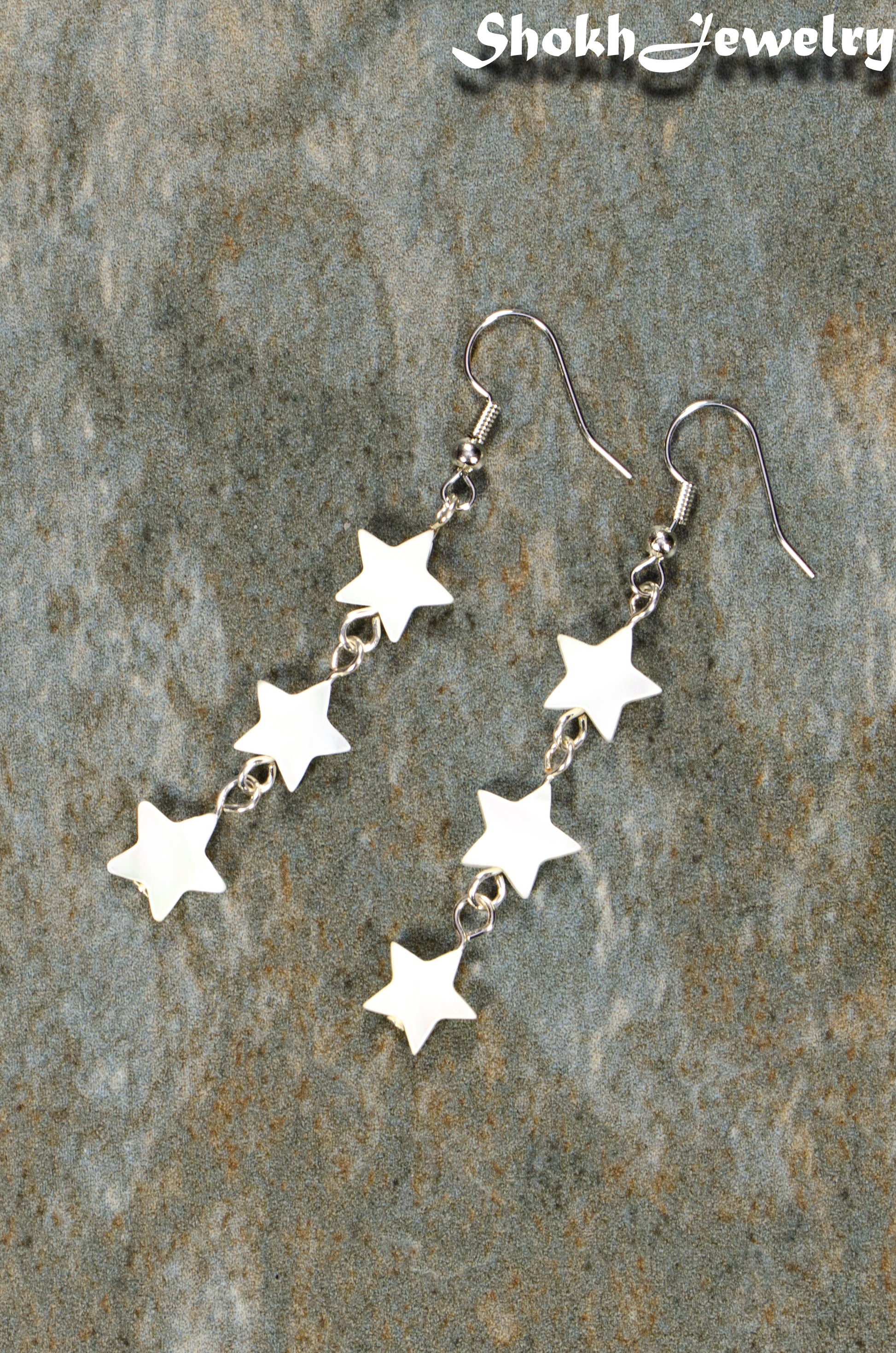 Top view of Long Natural White Seashell Star Earrings.