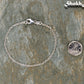2.5mm Silver Plated Dainty Chain Bracelet beside a dime.