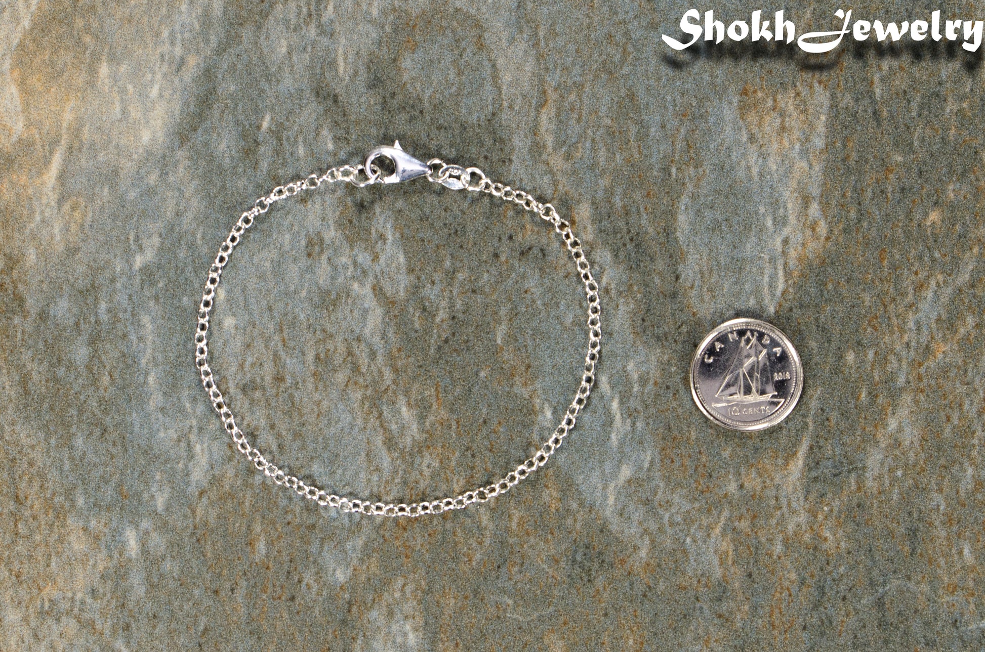 2.5mm Silver Plated Dainty Chain Bracelet beside a dime.