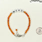 Personalized Carnelian Crystal Bracelet with Clasp beside a dime.
