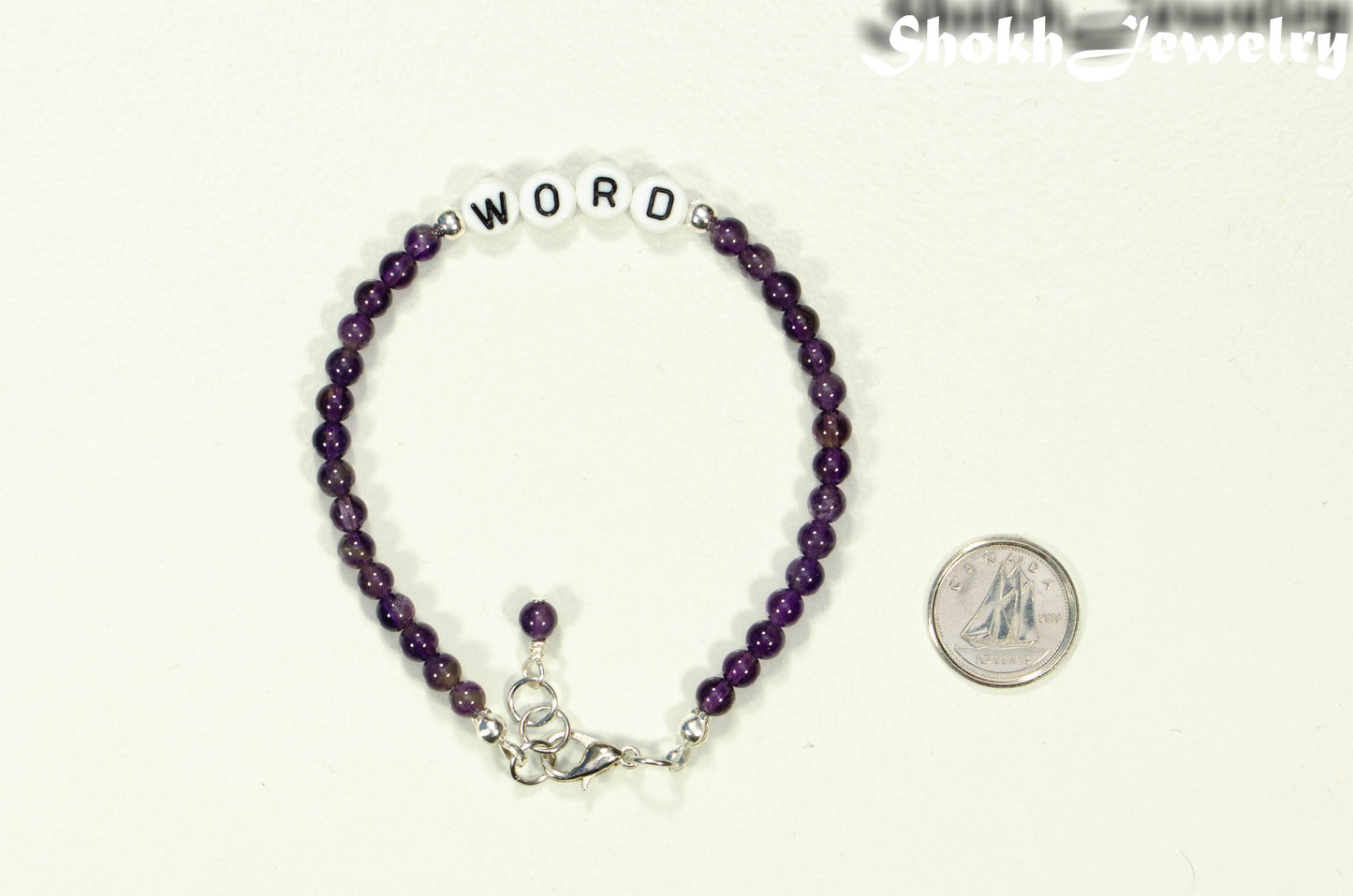 Personalized Amethyst Bracelet with Clasp beside a dime.
