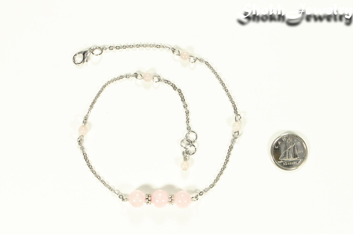 Natural Rose Quartz and Chain Choker Necklace beside a dime.