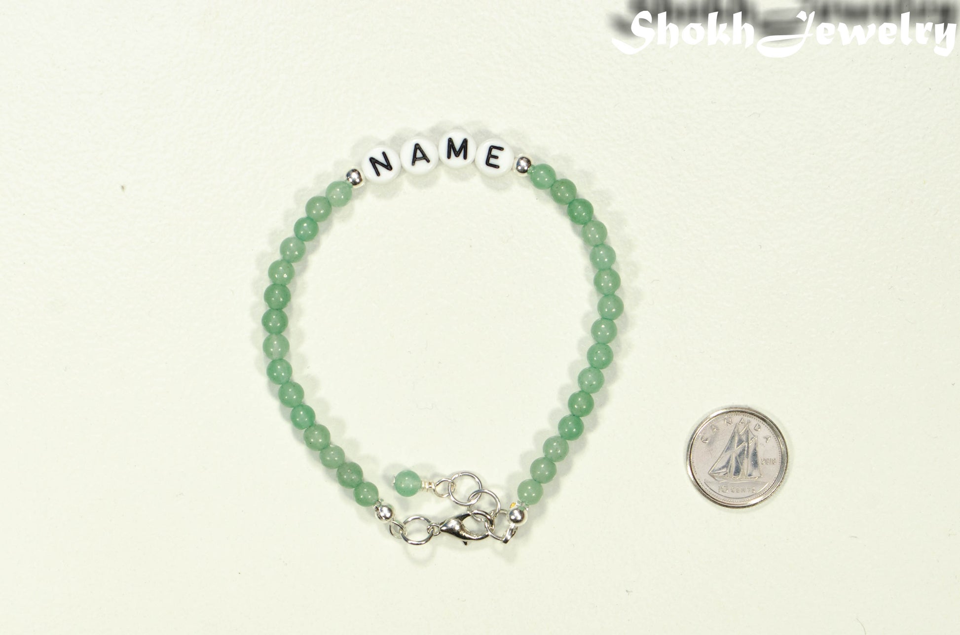 Personalized Green Aventurine Bracelet with Clasp beside a dime.