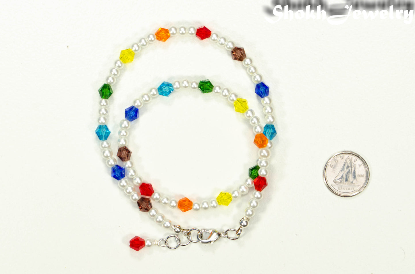 Rainbow Glass Crystal Bead and Pearl Anklet beside a dime.