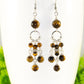 Close up of Statement Tiger's Eye Chandelier Earrings.