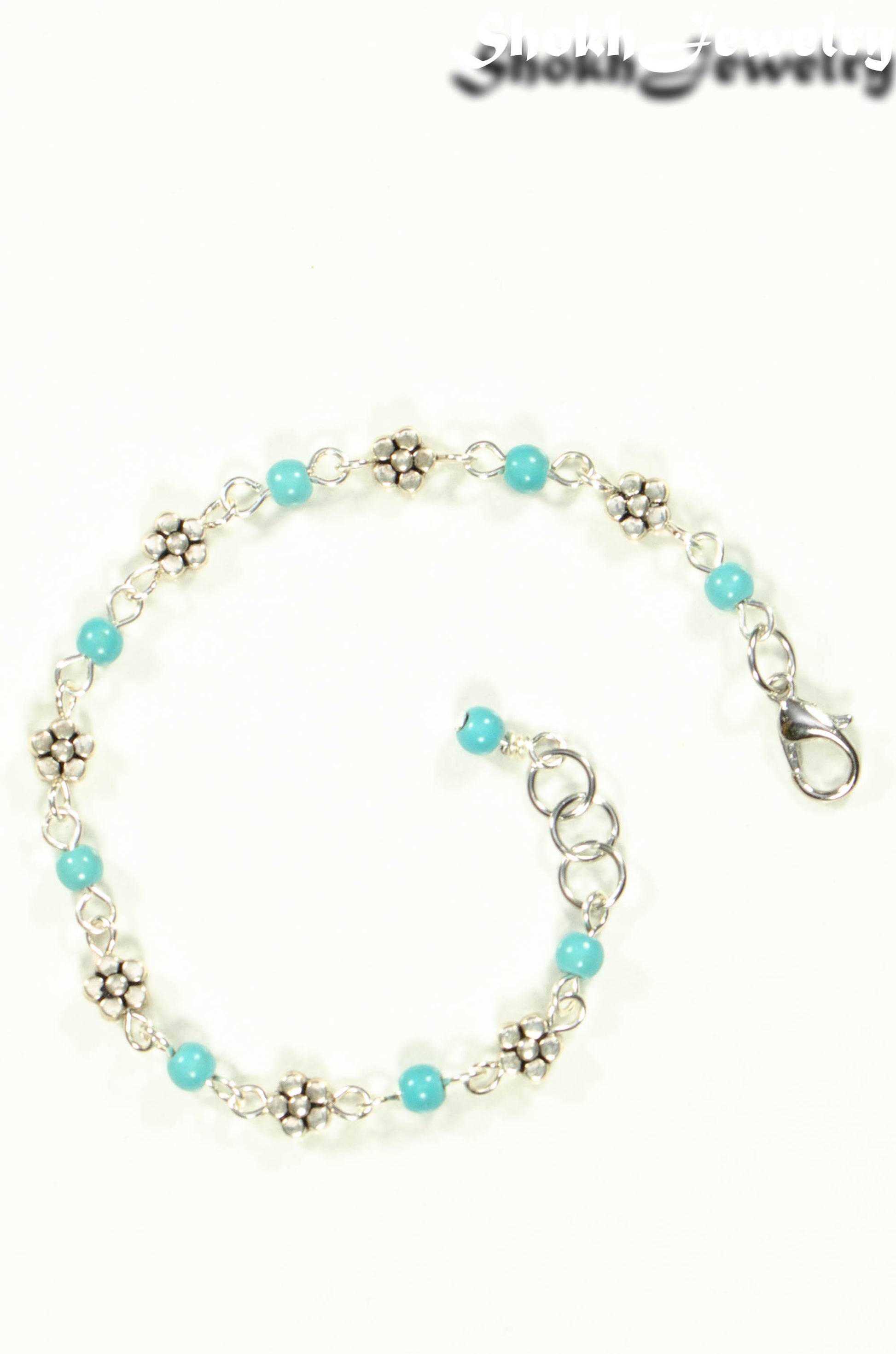 Top view of Tibetan Silver Flower and Turquoise Howlite Link Bracelet.