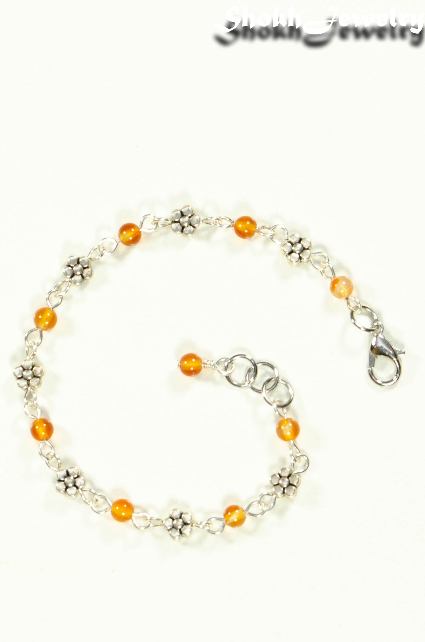 Top view of Tibetan Silver Flower and Carnelian Link Bracelet.