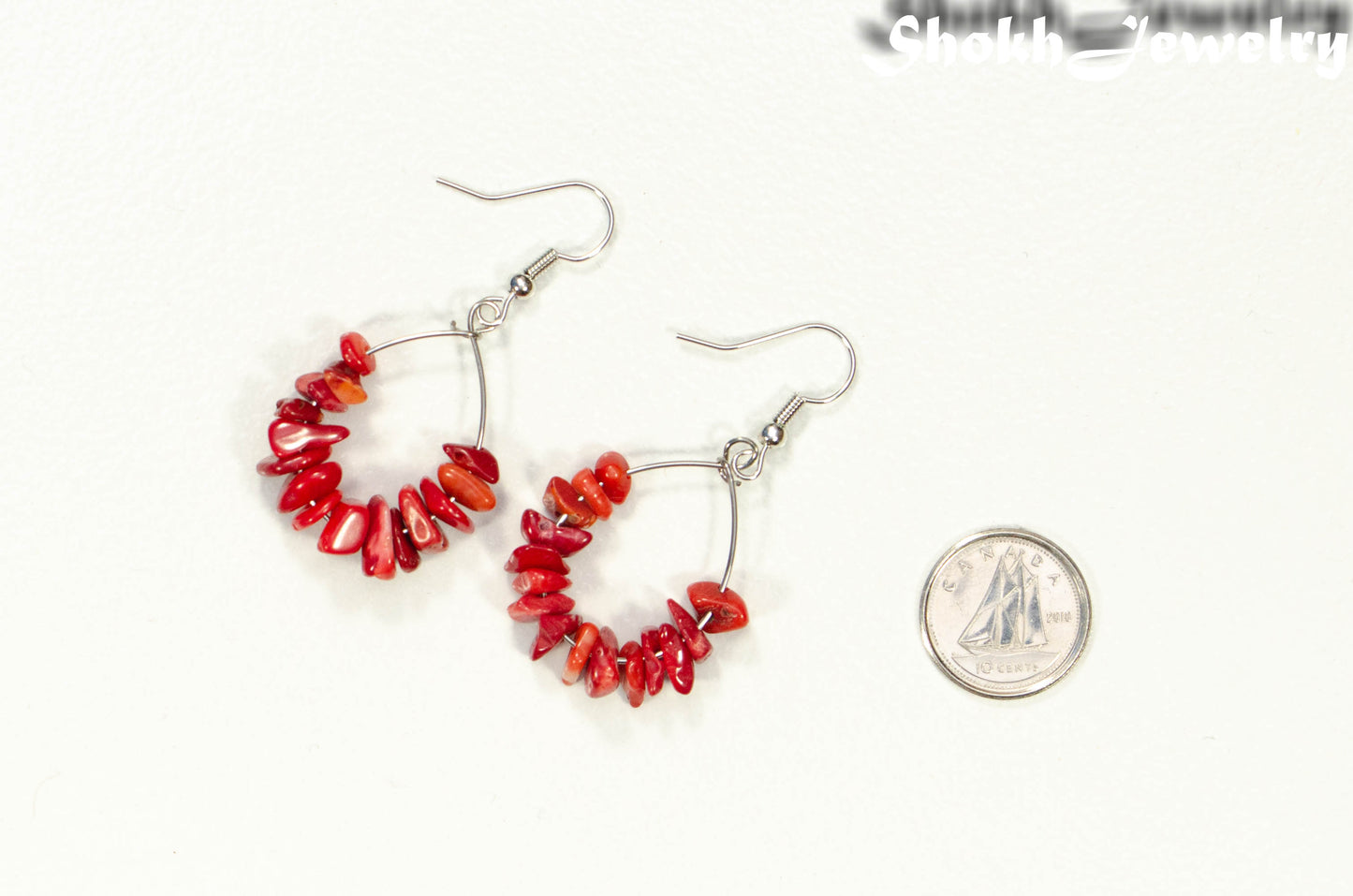 Natural Red Coral Crystal Chip Earrings beside a dime.