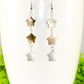 Close up of Long Natural Seashell Star Earrings.