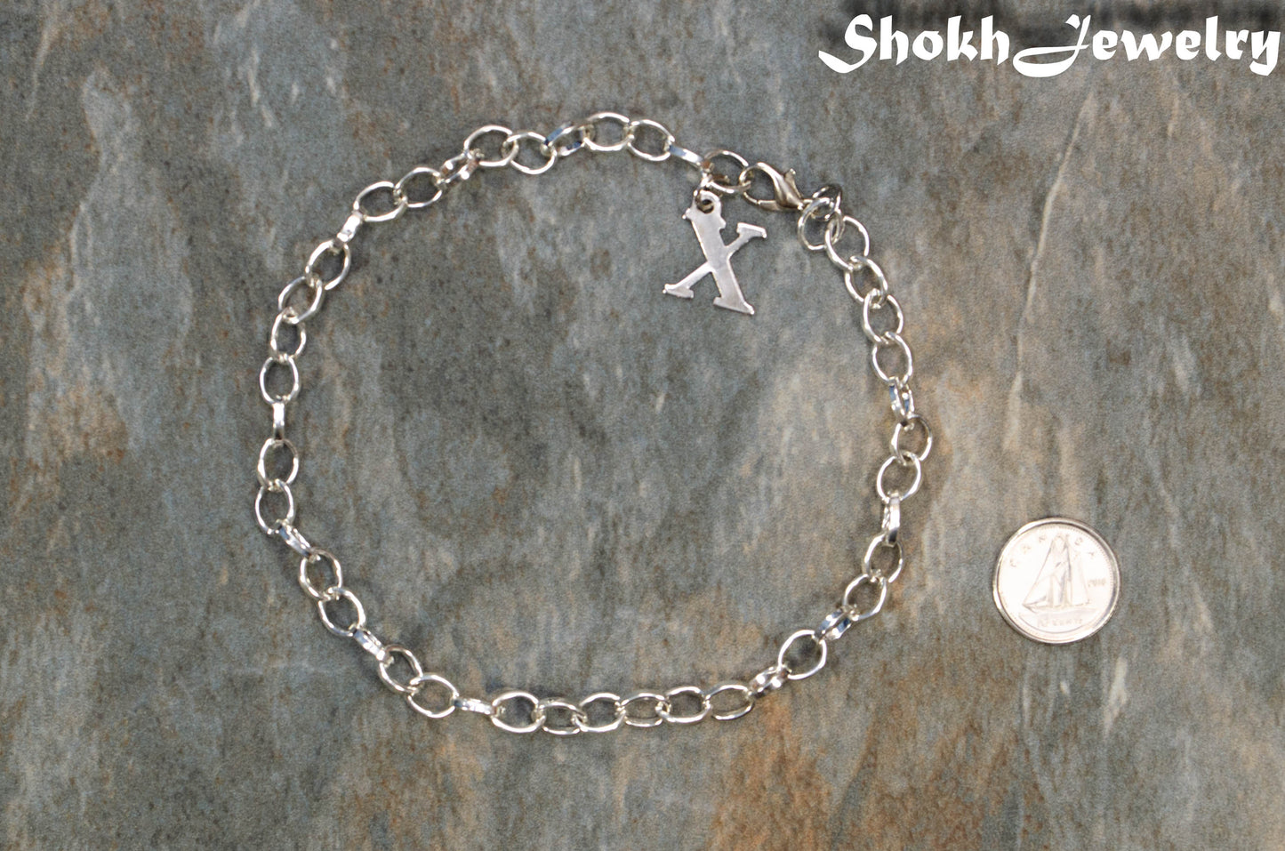 Personalized Initial and Chunky Chain Anklet beside a dime.