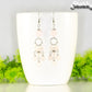 Statement Rose Quartz Chandelier Earrings displayed on a white coffee mug.