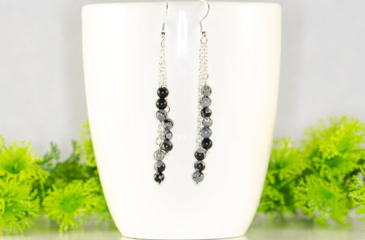 Silver Plated Chain and Snowflake Obsidian Stone Earrings displayed on a coffee mug.