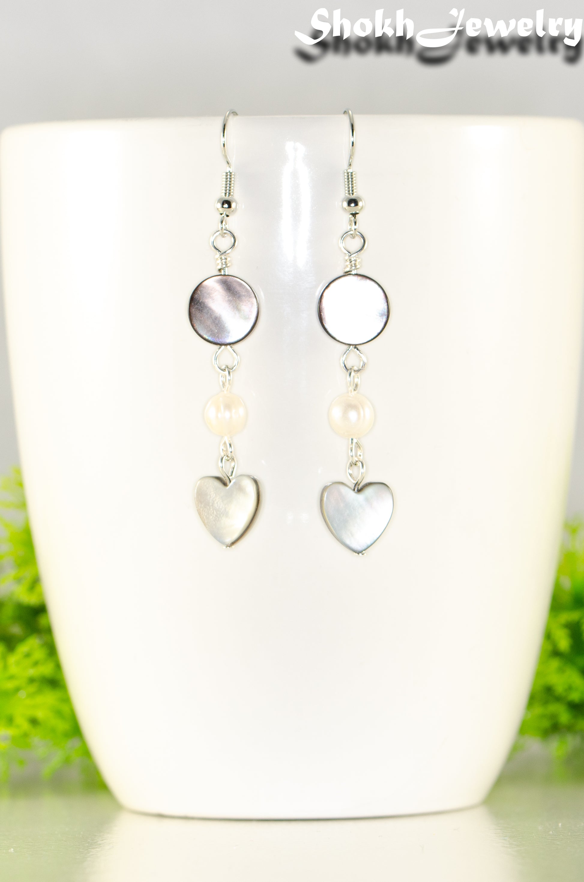 Close up of Grey Seashell and White Pearl Earrings.