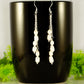 Long Silver Plated Chain and Freshwater Pearl Earrings displayed on a coffee mug.