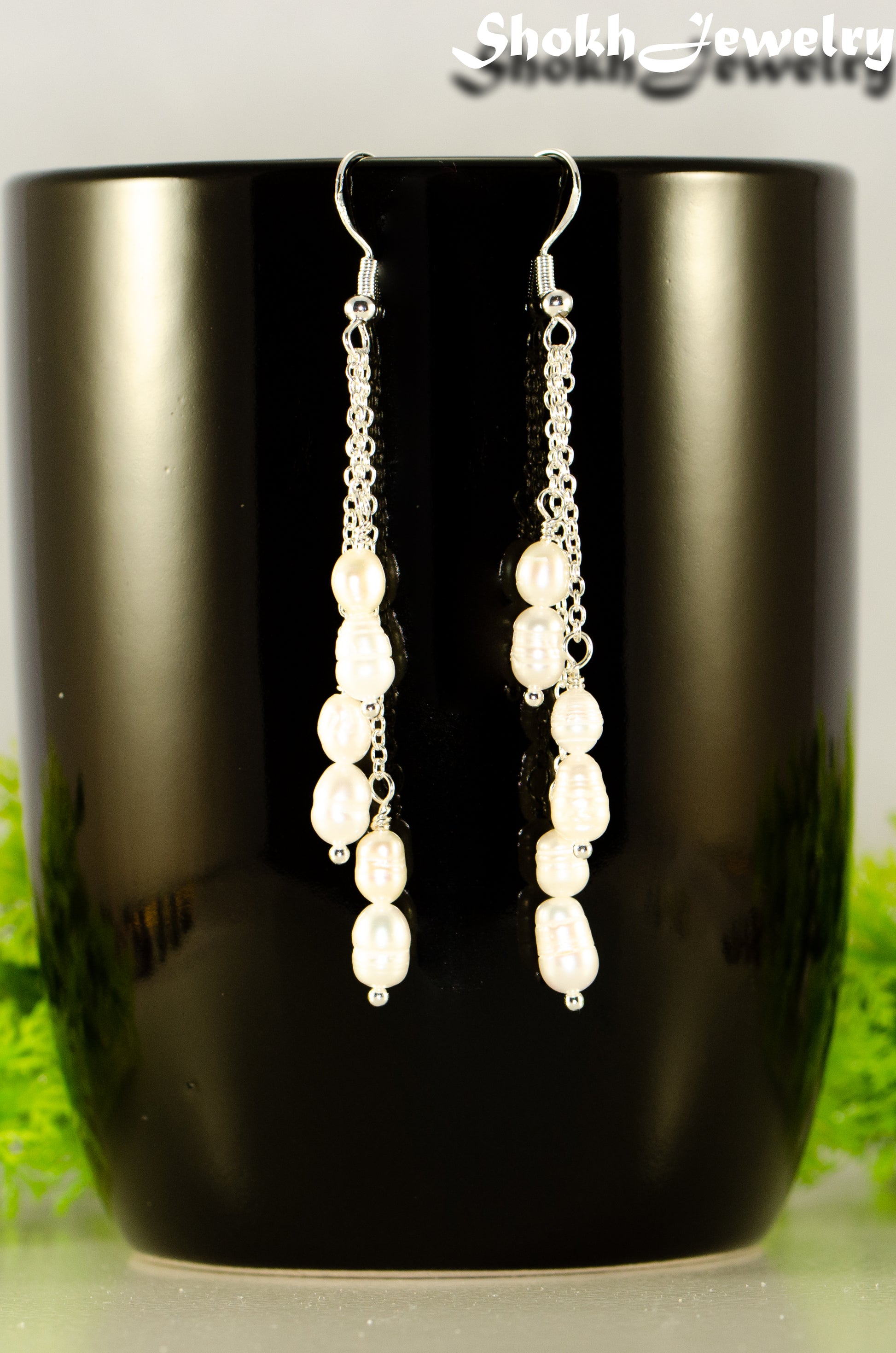 Close up of Long Silver Plated Chain and Freshwater Pearl Earrings.