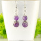 Natural Amethyst Dangle Earrings displayed on a tea cup.