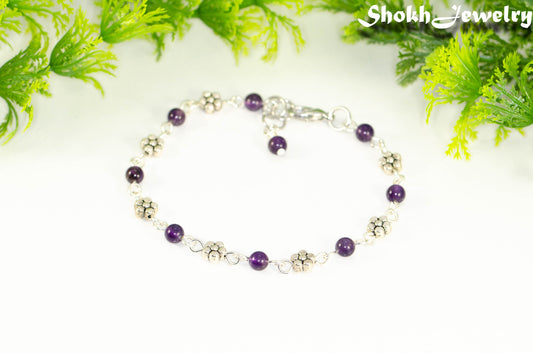 Tibetan Silver Flower and Amethyst Link Bracelet with lobster claw clasp closure.