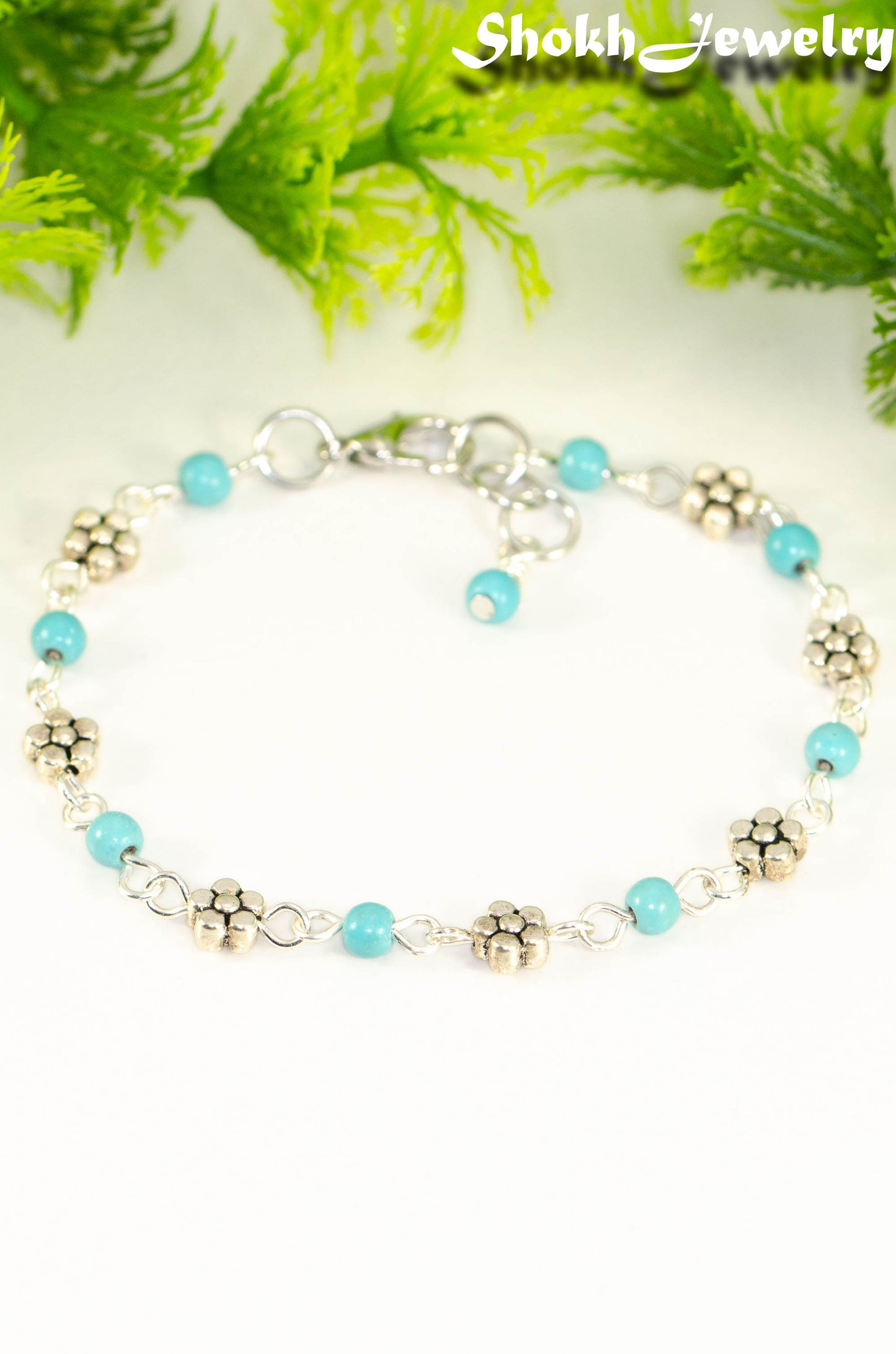 Close up of Tibetan Silver Flower and Turquoise Howlite Link Bracelet.