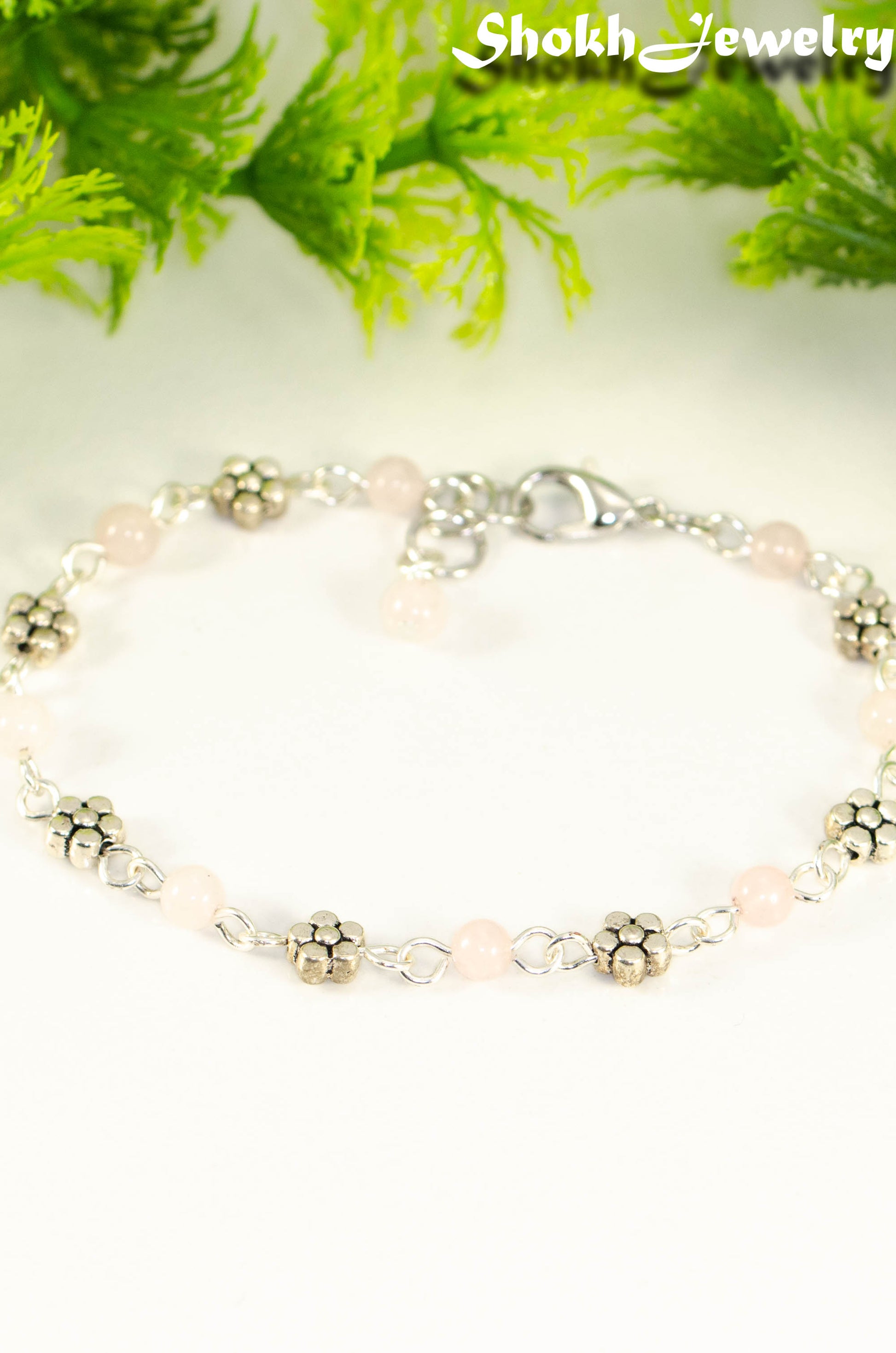 Close up of Tibetan Silver Flower and Rose Quartz Link Bracelet.